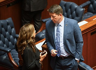 Arkansas state Sen. Missy Irvin (left), R-Mountain View, talks with Sen. Josh Bryant, R-Rogers, on the floor of the Arkansas Senate before the start of a Senate floor session at the state Capitol in this April 24, 2024 file photo. The two sponsored bills on the regulation of crypto mining in Arkansas. (Arkansas Democrat-Gazette/Stephen Swofford)